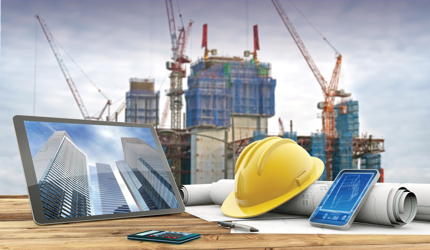 blueprints and safety helmet over a table in construction site